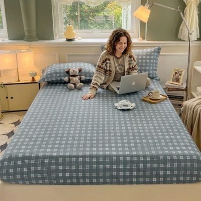 femme travaillant avec portable assie sur draps housse