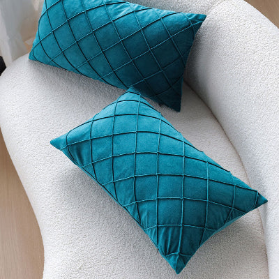 housse de coussin 30x50 verte déposée sur canapé