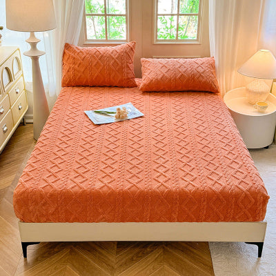 housse de matelas orange sur lit