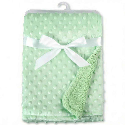 plaid bébé vert plier et orner dun ruban