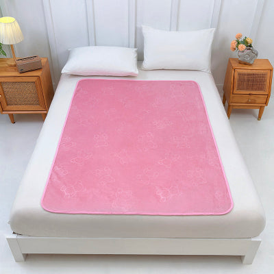 protection pour matelas rose étendue sur lit